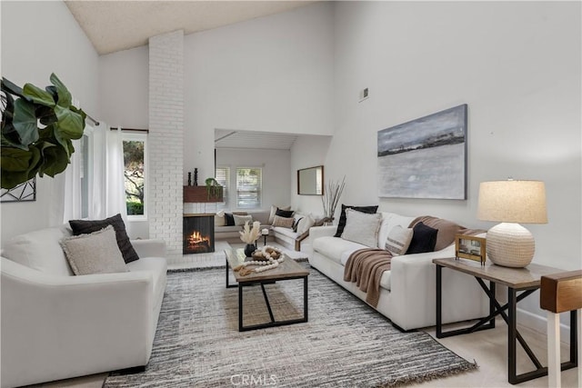 living room featuring a towering ceiling and a fireplace