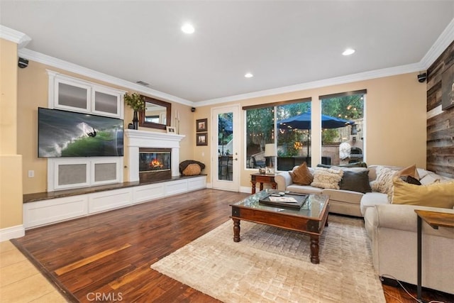 living room with hardwood / wood-style flooring and crown molding