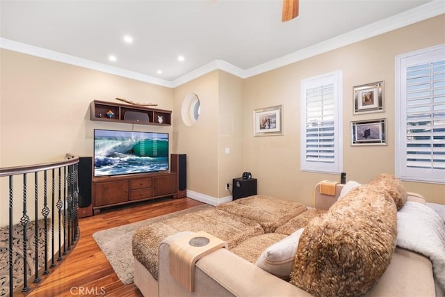 living room with ceiling fan, ornamental molding, and light hardwood / wood-style floors