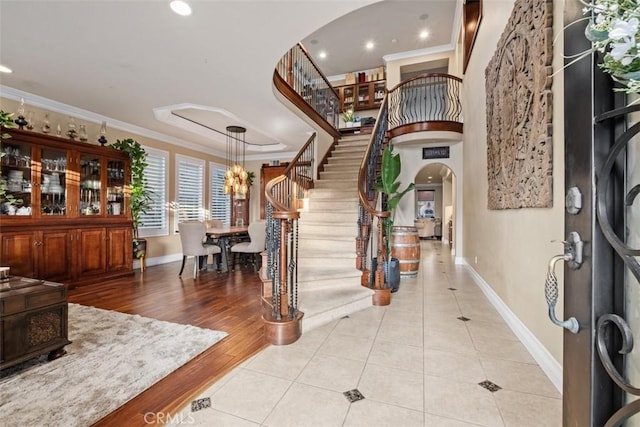 foyer featuring ornamental molding and light wood-type flooring