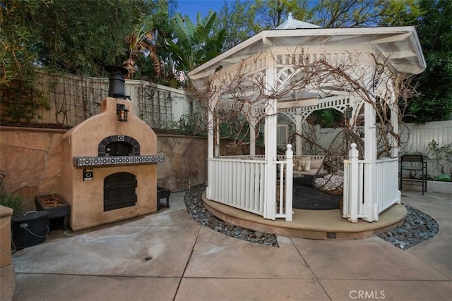 view of patio / terrace featuring a gazebo and a fireplace