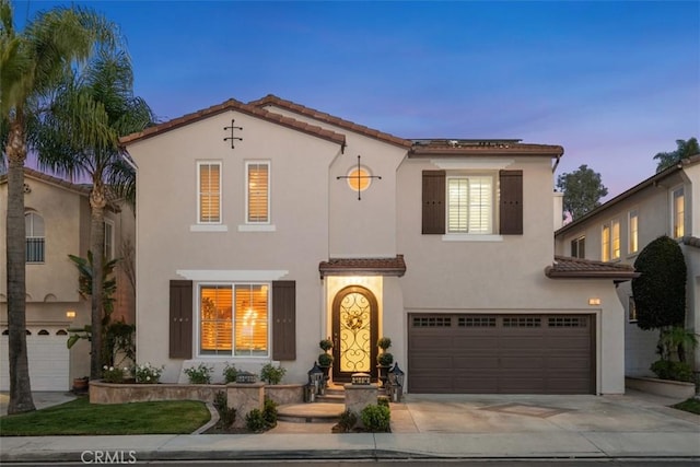 mediterranean / spanish-style home with a garage