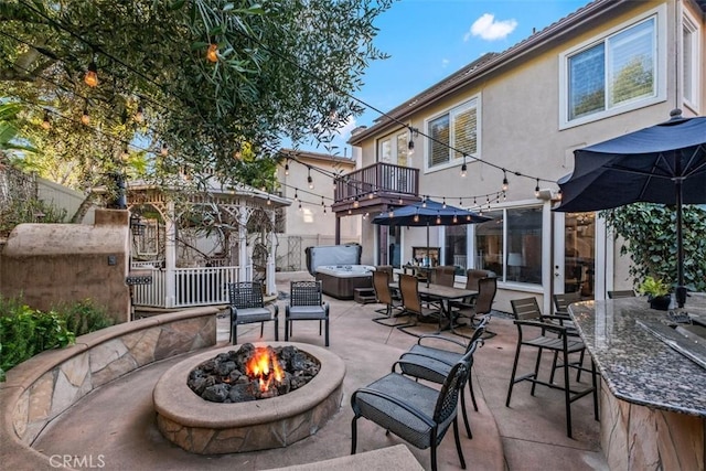 view of patio featuring a fire pit and a hot tub