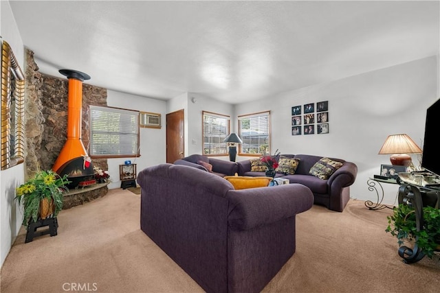 living room featuring light carpet and a wood stove