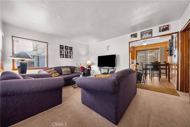 living room with a wealth of natural light and light colored carpet