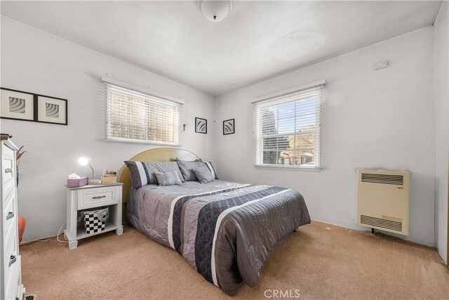 carpeted bedroom with heating unit