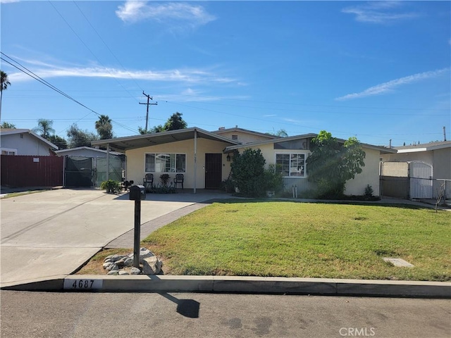 single story home featuring a carport and a front yard