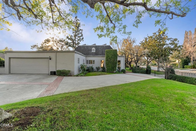 view of front of property with a garage and a front yard