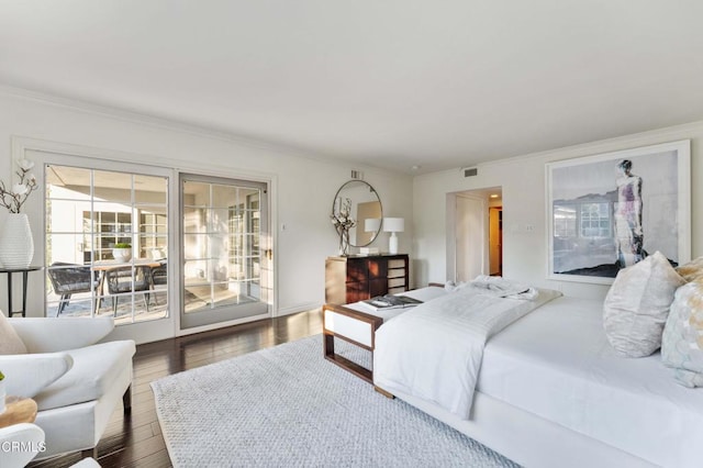 bedroom featuring ornamental molding, dark hardwood / wood-style floors, and access to outside