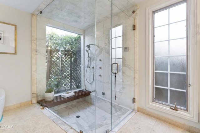 bathroom featuring plenty of natural light and a shower with shower door