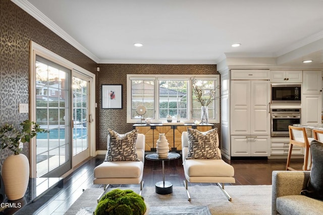 living area with crown molding, plenty of natural light, and dark wood-type flooring