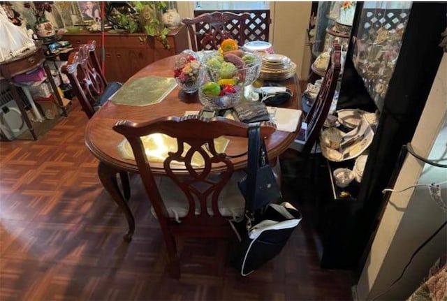 dining space featuring dark parquet floors