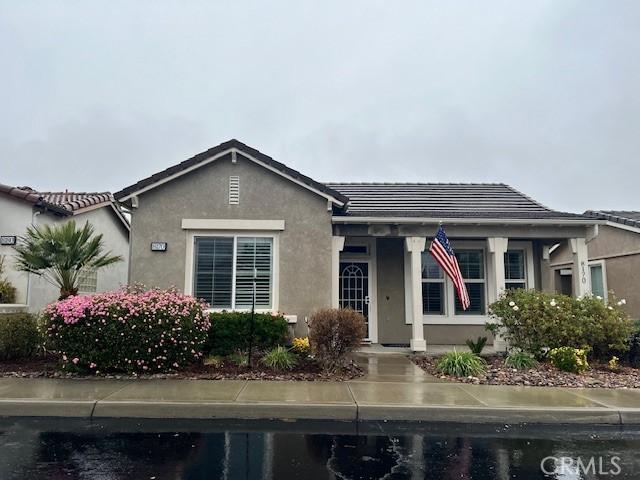 bungalow featuring stucco siding