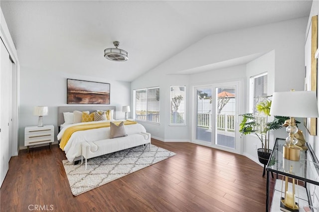 bedroom featuring access to exterior, dark hardwood / wood-style flooring, and vaulted ceiling