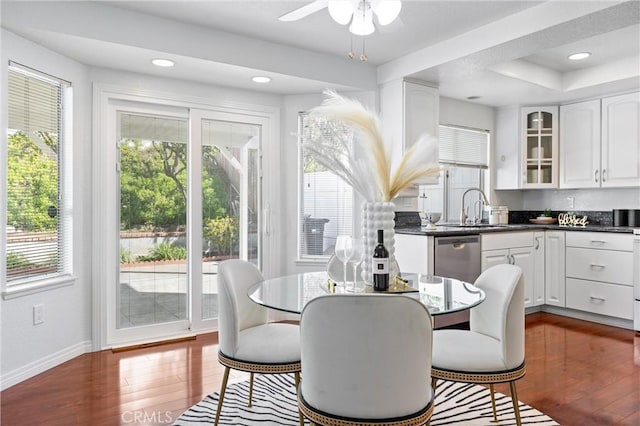 dining room featuring ceiling fan, dark hardwood / wood-style flooring, and sink