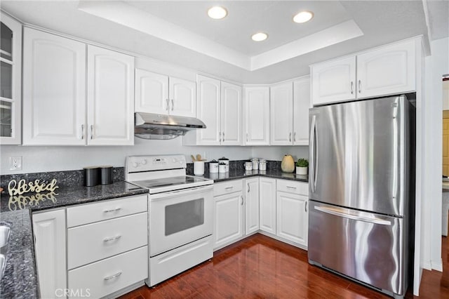 kitchen with dark hardwood / wood-style floors, stainless steel refrigerator, white cabinetry, electric range, and a tray ceiling