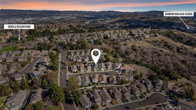 aerial view at dusk featuring a mountain view