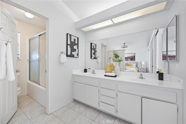 full bathroom featuring vanity, tile patterned floors, enclosed tub / shower combo, and toilet