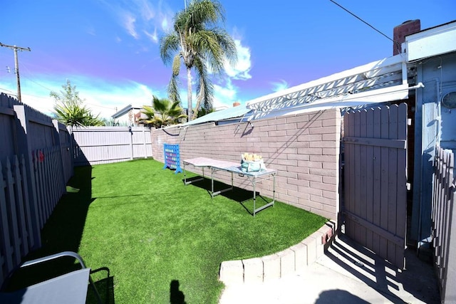 9452 Larrabee Ave, San Diego, CA 92123 - yard at dusk featuring a fenced backyard and a gate