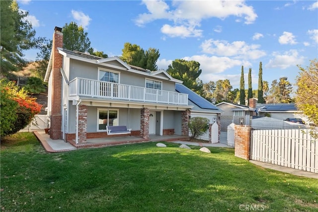 view of front of home featuring a balcony and a front lawn