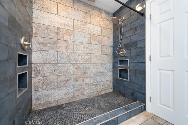 bathroom with tiled shower