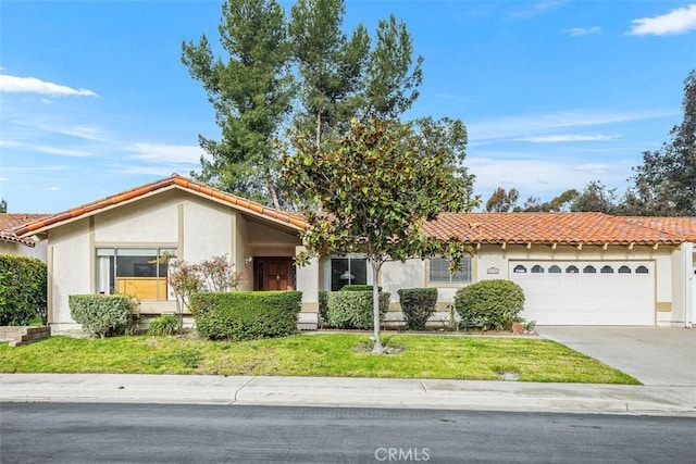 view of front of home featuring a garage and a front lawn