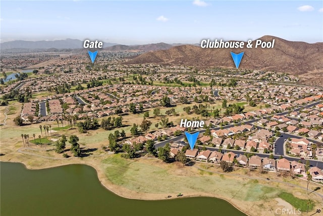 birds eye view of property featuring a water and mountain view