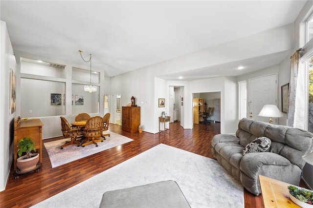 living room featuring dark hardwood / wood-style flooring and a chandelier