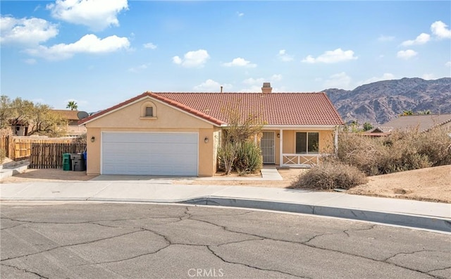 view of front facade featuring a mountain view and a garage