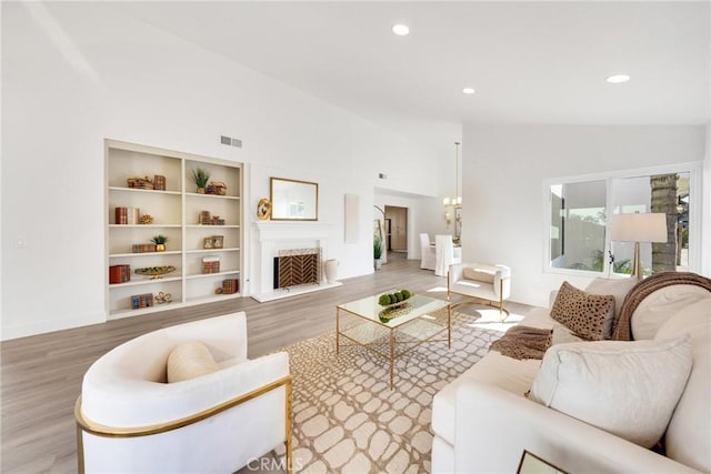 living room featuring wood-type flooring and high vaulted ceiling