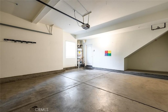 garage with a garage door opener and strapped water heater