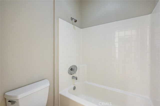 bathroom featuring shower / bathtub combination and toilet