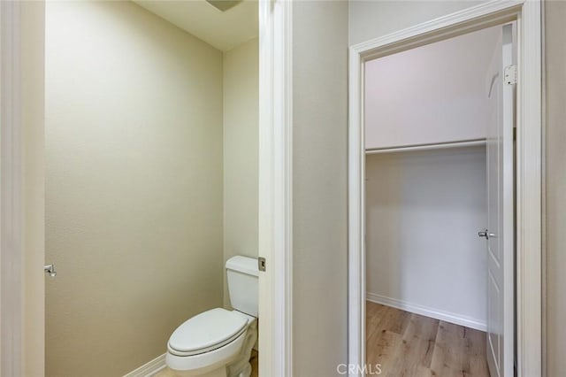 bathroom with wood-type flooring and toilet