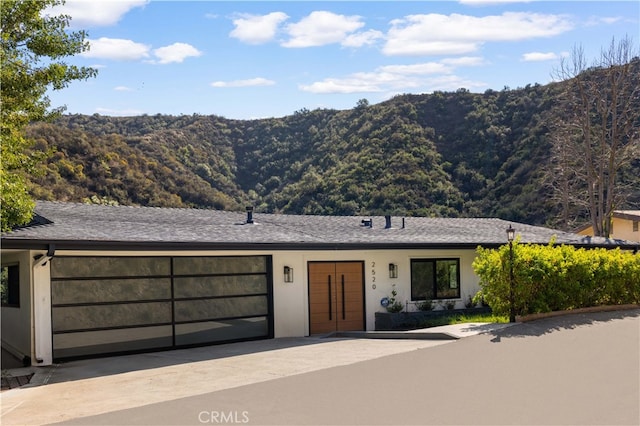 single story home with a mountain view and a garage