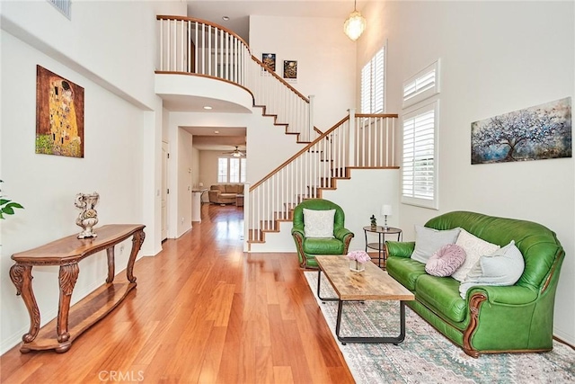 entryway with a towering ceiling and hardwood / wood-style floors