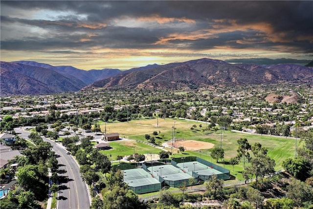 aerial view at dusk featuring a mountain view