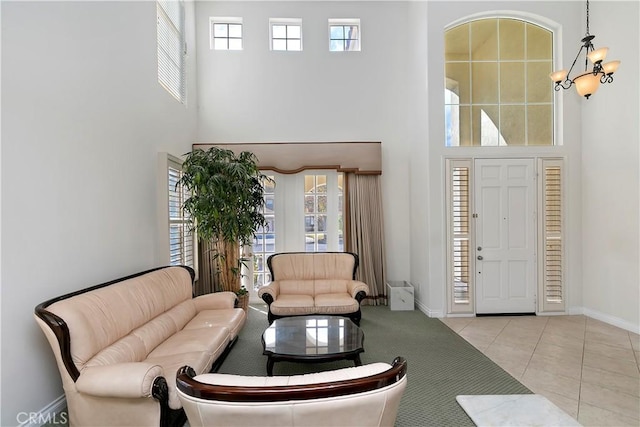 tiled living room with a chandelier and a high ceiling