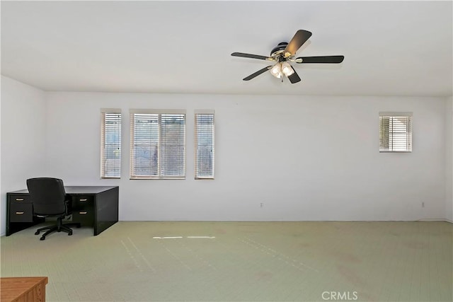 carpeted office featuring ceiling fan