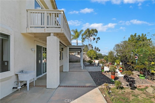 view of patio / terrace with sink and a balcony