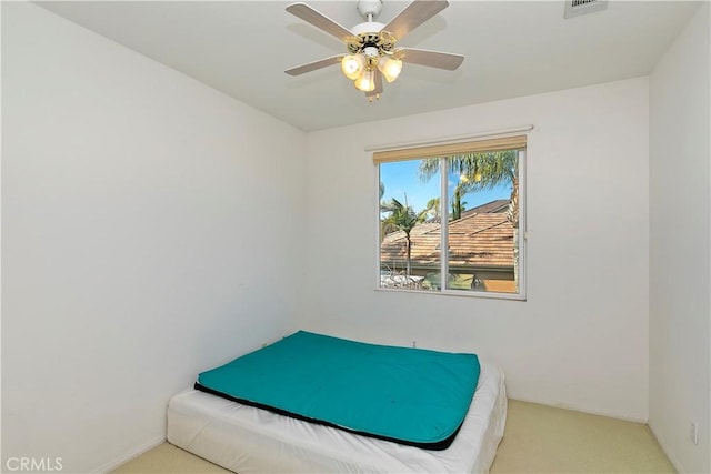 bedroom featuring light carpet and ceiling fan