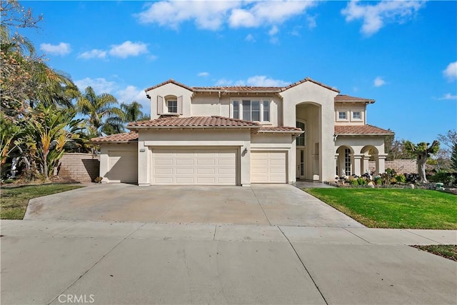 mediterranean / spanish-style home featuring a garage and a front yard