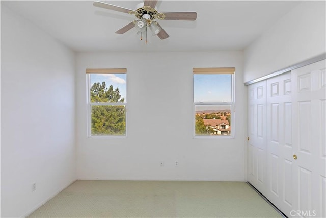 carpeted empty room with ceiling fan