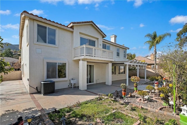 back of property with a pergola, central AC, a patio, and a balcony