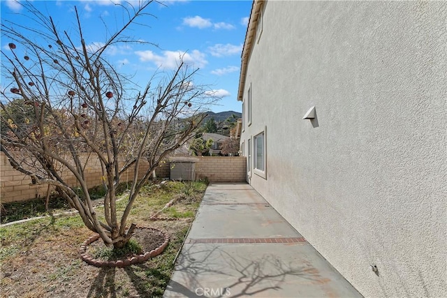 view of side of home with a patio