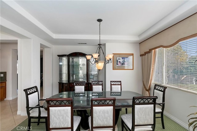 dining area with a chandelier and light tile patterned floors