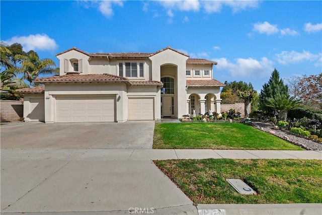 mediterranean / spanish house featuring a garage and a front lawn