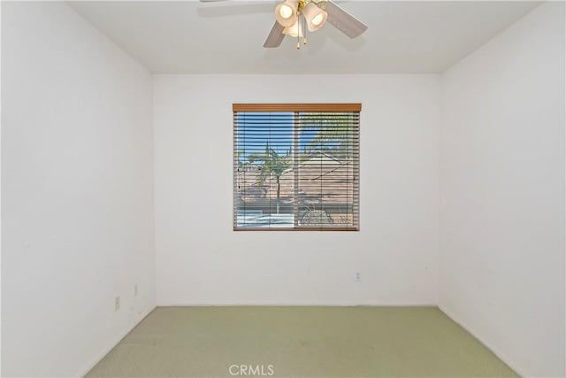 spare room featuring carpet flooring and ceiling fan