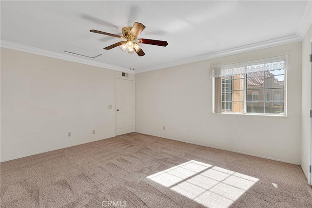 carpeted empty room featuring ornamental molding and ceiling fan