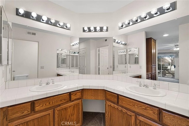 bathroom with vanity and ceiling fan