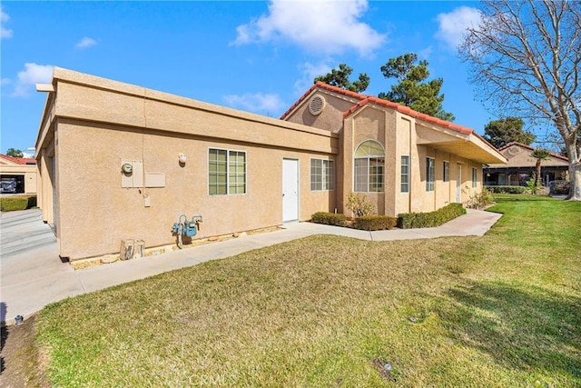 rear view of property with a lawn